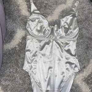Size M. Silk white body suit from Amazon. Never worn.